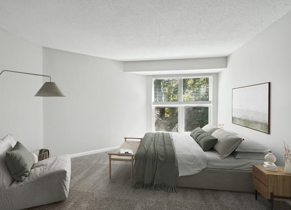 Model Bedroom with Carpet and Window View at Arbor Village Apartments located in Charlotte, NC.