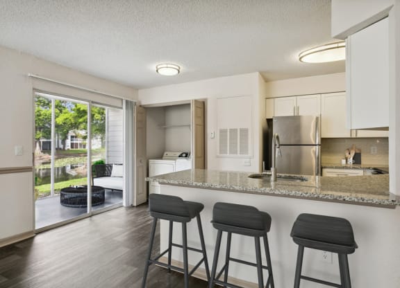 Model kitchen with bar at Retreat at Crosstown Apartments