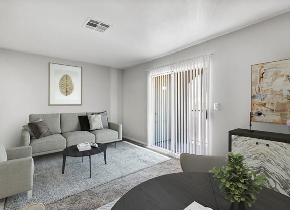 Model Living Room and Dining Room Area with Carpet at Loma Vista Apartments in Las Vegas, NV.