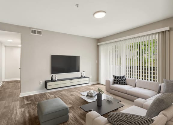 Model living room filled with furniture and a flat screen tv
