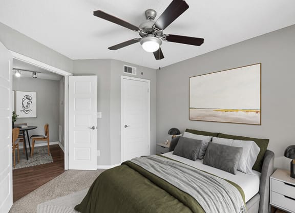 Model Bedroom with Carpet and View of Dining Room Area at Fountains Lee Vista Apartments in Orlando, FL.