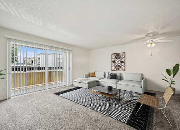 Model Classic Living Room with Carpet and Patio Accessibility at Butler Ridge Apartments located in Glendale, AZ.