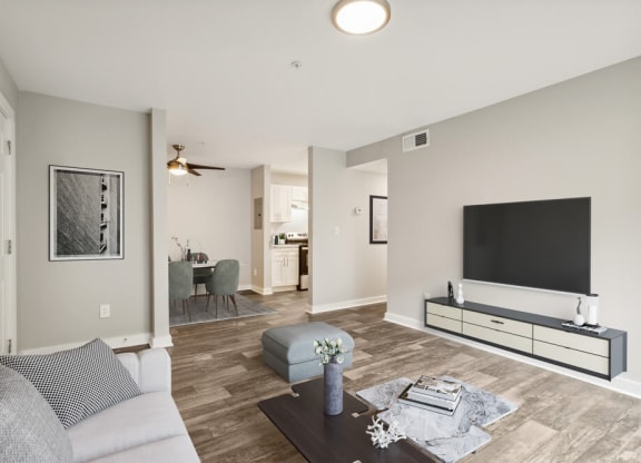Model living room with a large tv on the wall