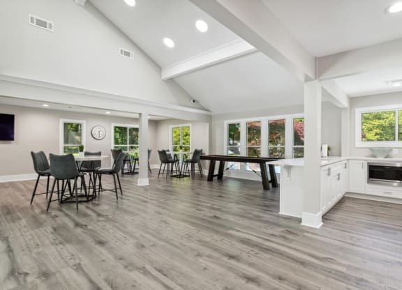 Community Clubhouse with Island Bar and Lounge Furniture and Game Tables at Dunwoody Village Apartments in Atlanta, GA.
