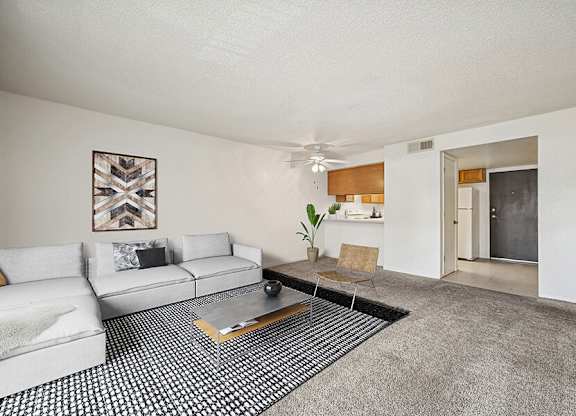Model Classic Living Room with Carpet and Patio Accessibility at Butler Ridge Apartments located in Glendale, AZ.