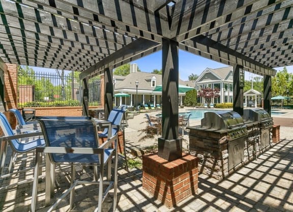 Poolside BBQ area with cabanas