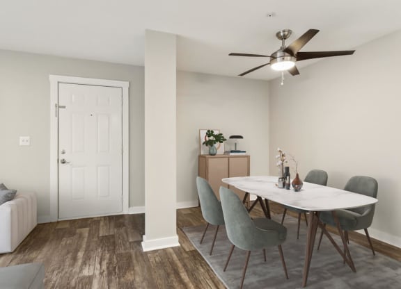 Model dining area with a table and chairs and a ceiling fan