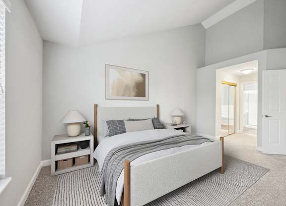 Model Bedroom with Carpet and attached Bathroom at Dulles Green Apartments located in Herndon, VA.