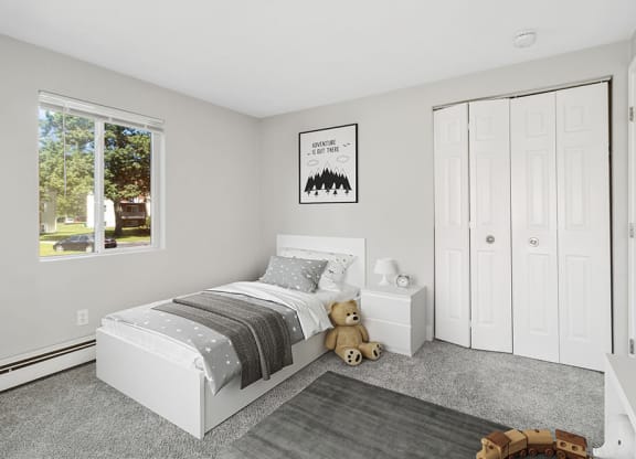 Model second bedroom with plush carpeting