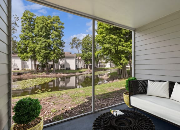 Patio with a couch and a cof fee table at Retreat at Crosstown Apartments