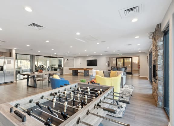 Community Clubhouse with Lounge Furniture and Pool Table Area at Liberty Creek Apartments in Aurora, CO.