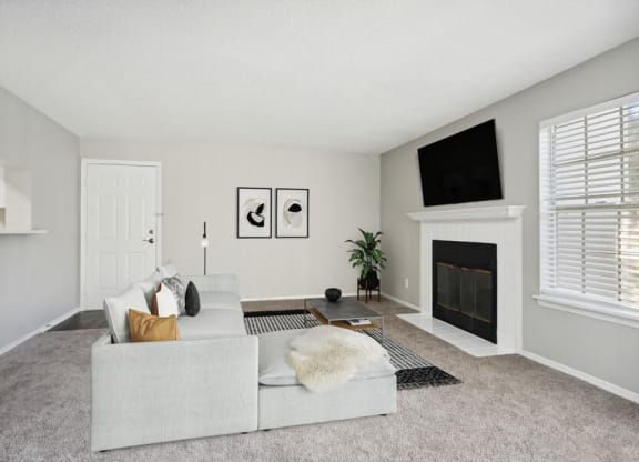 Model Living Room with Front Door and a Fireplace at Caribbean Breeze Apartments in Tampa, FL.