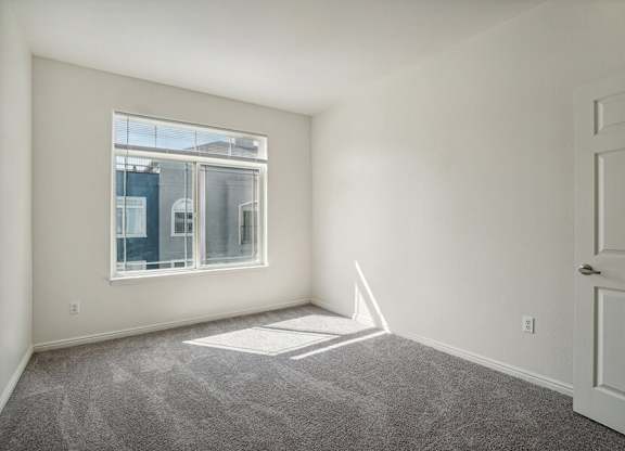 Model Bedroom with Carpet and Window View at Altitude on Fifth Apartments located in Salt Lake City, UT.