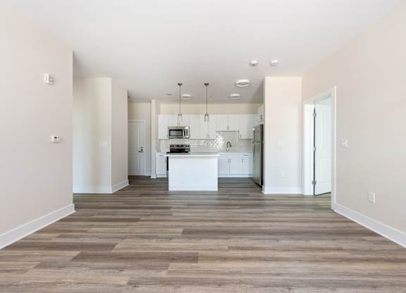 A kitchen with a white island in the middle of the room.