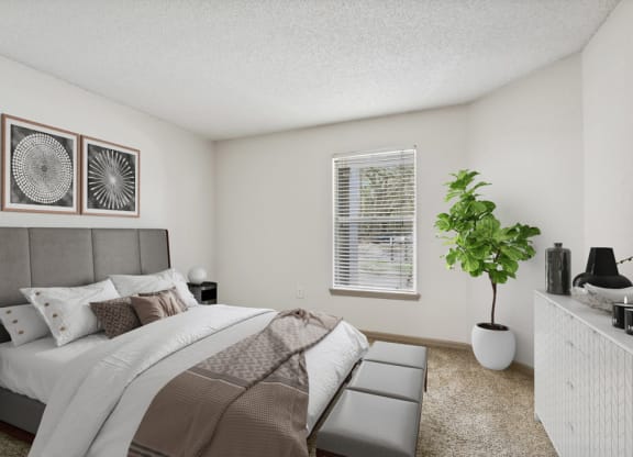 Model bedroom with a large bed at Retreat at Crosstown Apartments