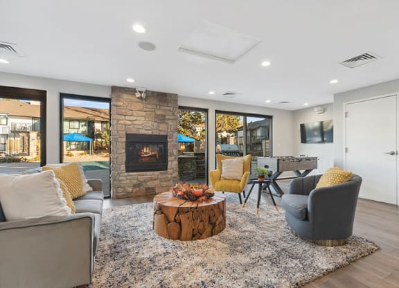 Community Clubhouse with Lounge Furniture and a Fireplace at Liberty Creek Apartments in Aurora, CO.