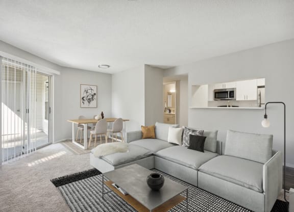 Model Living Room with Glass Sliding Door at Caribbean Breeze Apartments in Tampa, FL.