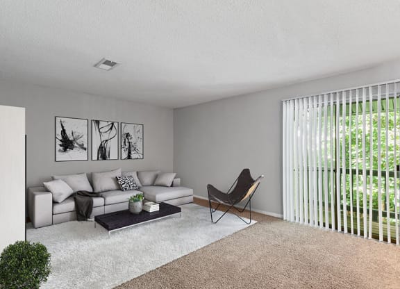Model Living Room with Carpet and Patio Accessibility at Corners at 1700 Apartments in Atlanta, GA.