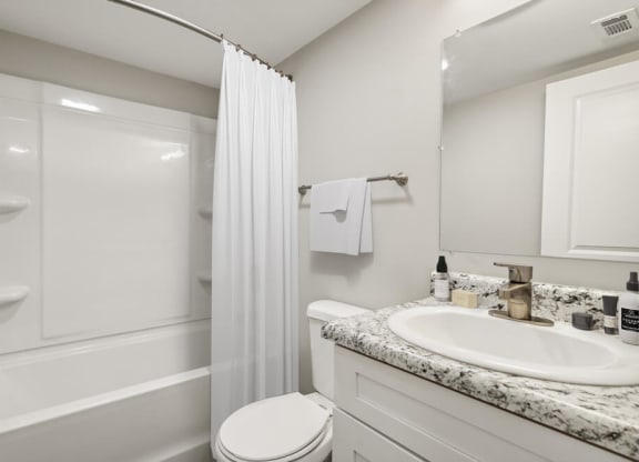 Model bathroom with a sink toilet and shower