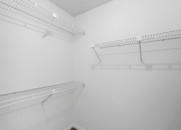 Model Bedroom Closet with Carpet at Fountains Lee Vista Apartments in Orlando, FL.