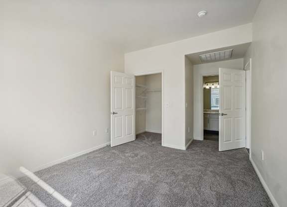 Model Bedroom with Carpet and Walk-In Closet at Altitude on Fifth Apartments located in Salt Lake City, UT.