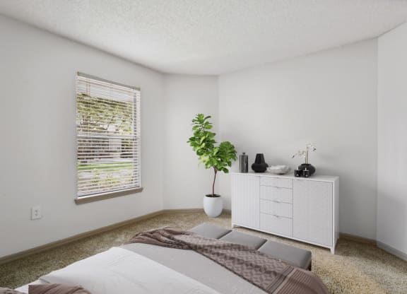 Model bedroom with carpeting at Retreat at Crosstown Apartments