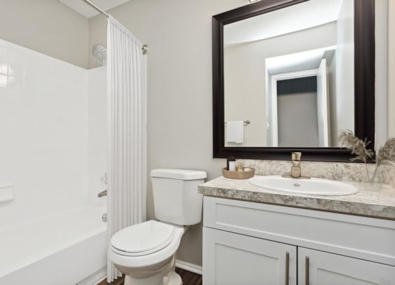 Model Bathroom with White Vanity at Caribbean Breeze Apartments in Tampa, FL.