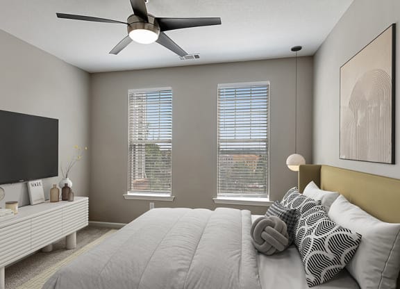 Model Bedroom with Carpet and Double Window View at Parkside at Town Center Apartments in Marietta, GA.