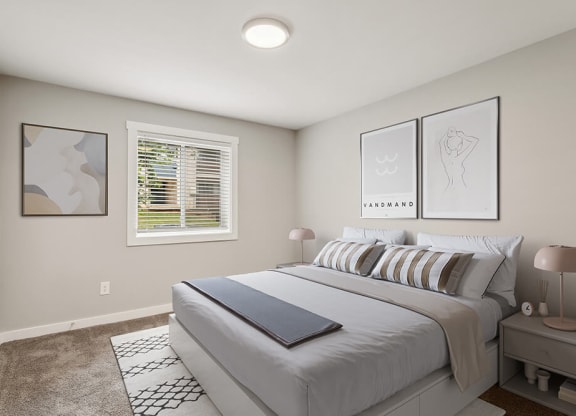 Model bedroom with a bed and a window