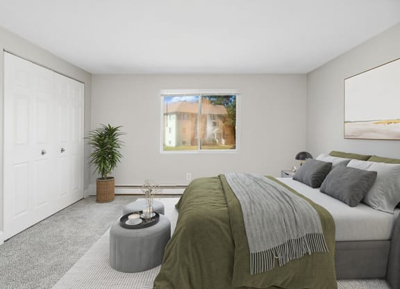 Model bedroom with queen bed and a window