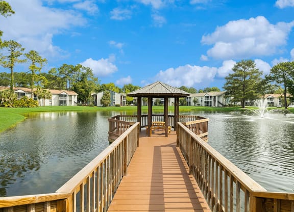 Gazebo at the end of a wooden dock overlooking a pond with a fountain at Vue at Baymeadows Apartments in Jacksonville, Florida