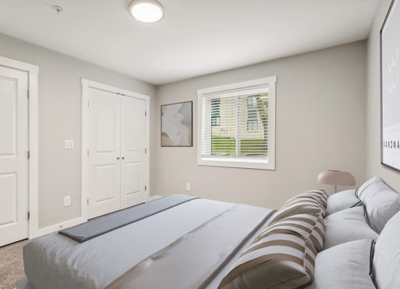 Model bedroom with a bed and a window