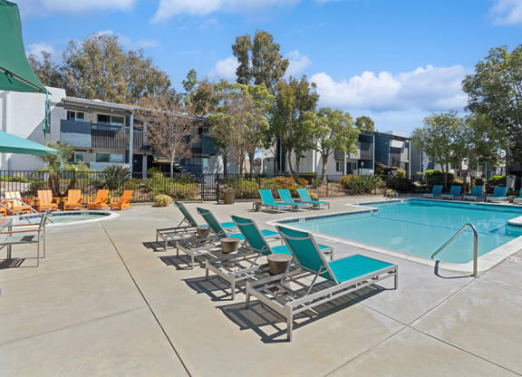 Community Swimming Pool with Pool Furniture at Colonnade at Fletcher Hills Apartments in El Cajon, CA.