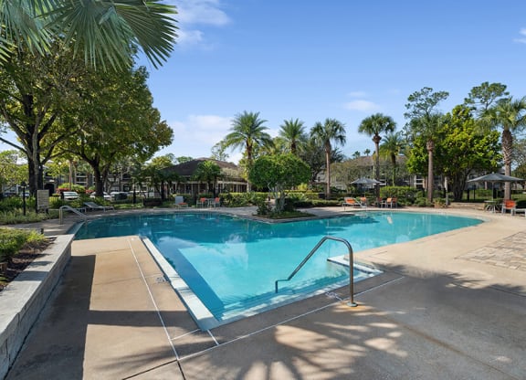 Community Swimming Pool with Pool Furniture at Fountains Lee Vista Apartments in Orlando, FL.
