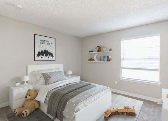 Model Bedroom with Carpet and Window View at Indigo Park Apartments in Albuquerque, NM.