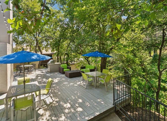 Outdoor Patio with Lounge Furniture & BBQ Grills at Woodcreek Apartments located in Arlington, TX.