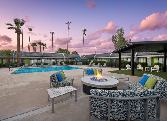 Outdoor Fire Pit Area and Swimming Pool with Lounge Furniture at Arcadia on 49th Apartments located in Phoenix, AZ.