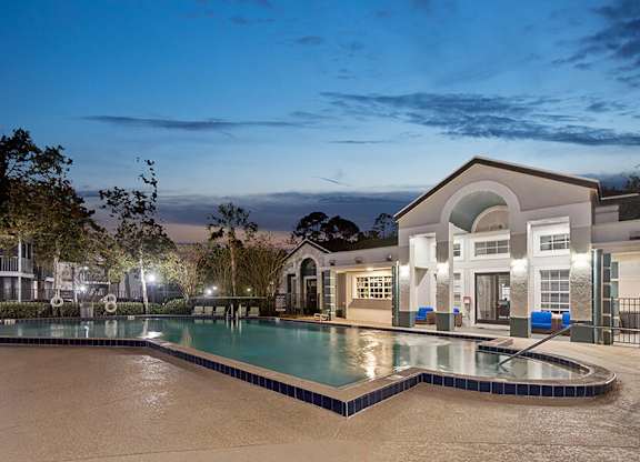 Community Swimming Pool with Pool Furniture at Vue at Baymeadows Apartments in Jacksonville, FL.
