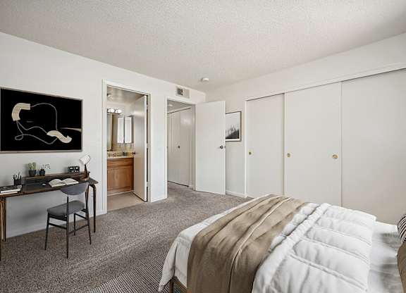 Model Bedroom with Carpet and attached Bathroom at Butler Ridge Apartments located in Glendale, AZ.
