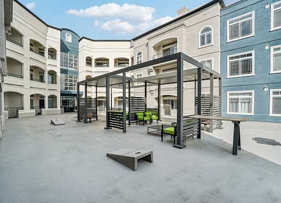 Rooftop Patio with Lounge Furniture and Cornhole at Altitude on Fifth Apartments located in Salt Lake City, UT.