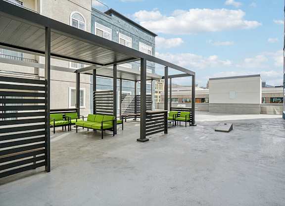Rooftop Patio with Lounge Furniture and Cornhole at Altitude on Fifth Apartments located in Salt Lake City, UT.