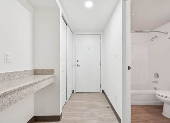A white bathroom with a toilet, sink, and bathtub.