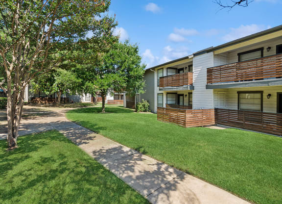 Exterior Community Building and Landscape at Woodcreek Apartments located in Arlington, TX.