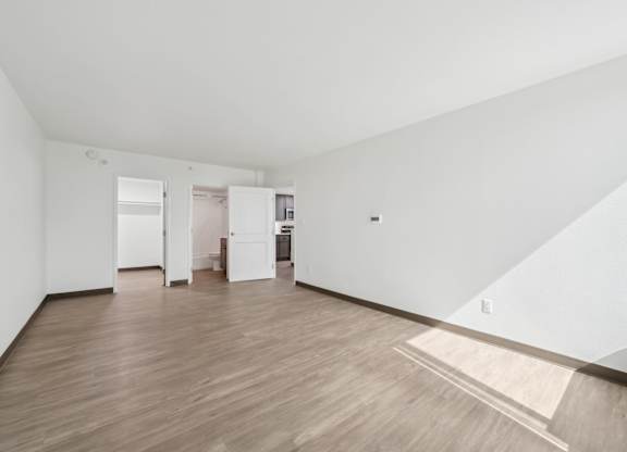A room with wooden floors and white walls.