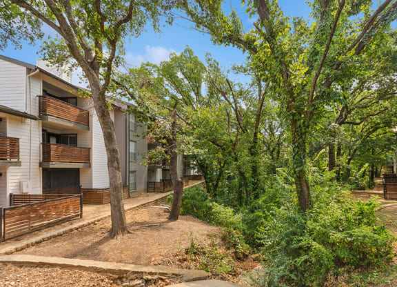 Exterior Community Building and Landscape at Woodcreek Apartments located in Arlington, TX.