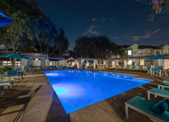 Community Swimming Pool with Pool Furniture at Essence Apartments in Dallas, TX.