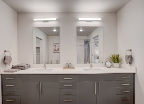 a large bathroom with two sinks and two mirrors