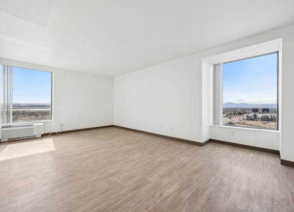 Empty room with a view of the cityscape outside the window.
