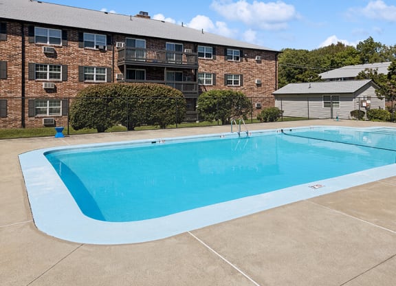 Community Swimming Pool with Pool Furniture at Middlesex Crossing Apartments located in Billerica, MA.