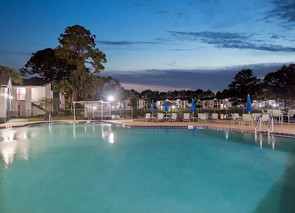 Community Swimming Pool with Pool Furniture at Vue at Baymeadows Apartments located in Jacksonville, FL.